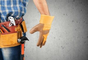 roofer with tool belt and yellow gloves